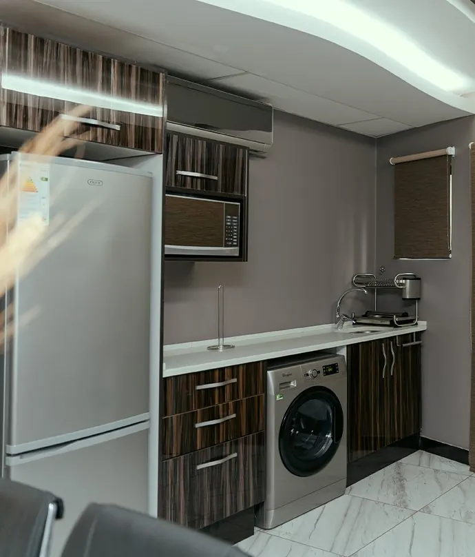 Kitchenette with a fridge and washing machine