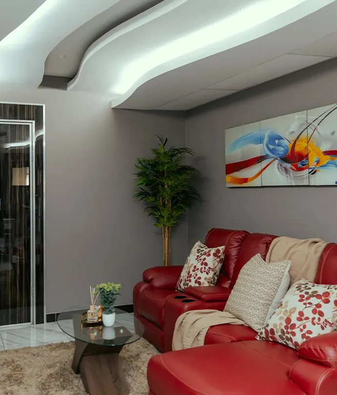 Lounge with a red sofa, cushions and bright artwork